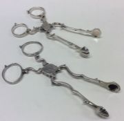 Two pairs of Georgian silver scissor action sugar