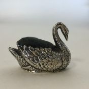 A novelty silver pin cushion in the form of a swan