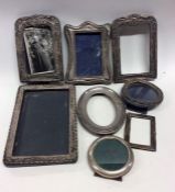 A group of silver embossed and other picture frame