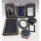 A group of silver embossed and other picture frame