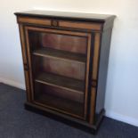 An ebony and walnut inlaid pier cabinet on bracket