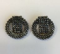 A pair of circular cut steel earrings. Approx. 15