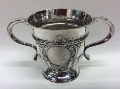 A Georgian half fluted two handled silver cup on s