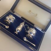 A good quality boxed three piece silver cruet set.