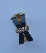 A stylish 18 carat diamond and onyx ring of crosso
