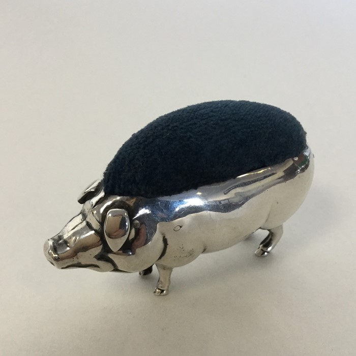 A novelty silver pin cushion in the form of a pig