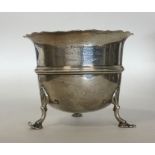 A silver sugar bowl with wavy edge on reeded suppo