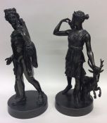 A pair of bronzed figures depicting hunters on cir