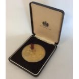A good heavy silver gilt boxed medallion depicting