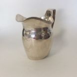 A large Georgian bright cut silver cream jug with