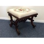 A Victorian piano stool with turned supports and u