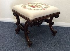 A Victorian piano stool with turned supports and u