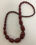 A heavy graduated string of amber beads. Approx. 9