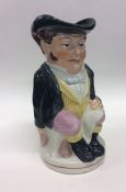 An Antique toby jug of typical design in seated po