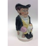 An Antique toby jug of typical design in seated po