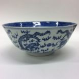 A Chinese blue and white bowl decorated with drago
