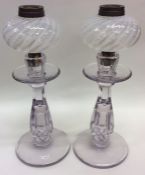 A pair of pale amethyst glass candlesticks together with twisted glass