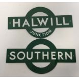 A pair of metal station signs for "Halwill Junctio