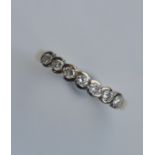 A good seven stone diamond half hoop ring in 18 ca