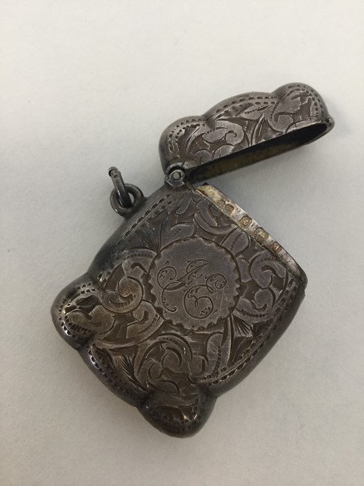 An Edwardian engraved silver vesta case decorated