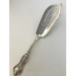 A large heavy silver fish slice with wavy edge. Lo