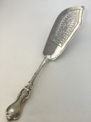 A large heavy silver fish slice with wavy edge. Lo