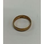 An 18 carat plain wedding band. Approx. 3 grams. E