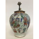 A Chinese table lamp decorated with figures and la