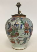 A Chinese table lamp decorated with figures and la