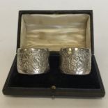 A heavy pair of boxed silver napkin rings with scr
