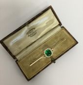 A good Antique pearl and green stone bar brooch in