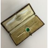 A good Antique pearl and green stone bar brooch in