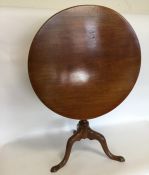 A mahogany pedestal pillar table on three tapering