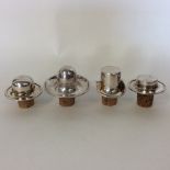 An unusual set of four silver plated wine stoppers