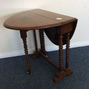 A small mahogany Sutherland table on turned suppor
