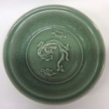 A large Chinese celadon bowl decorated with dragon