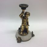 A small bronze and onyx candlestick in the form of