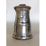 A silver churn shaped pepper grinder. Birmingham.