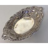 A small oval silver embossed sweet dish attractive