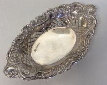 A small oval silver embossed sweet dish attractive
