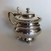 A Georgian circular silver mustard pot on ball fee