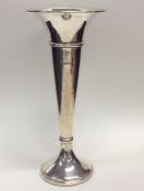 A massive silver tapering spill vase on spreading