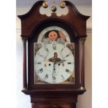 A large mahogany grandfather clock with canted cor