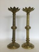 A pair of large Arts and Crafts brass candlesticks