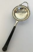 An Edwardian silver tea strainer with tapering han