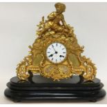 An attractive mantle clock flamboyantly decorated