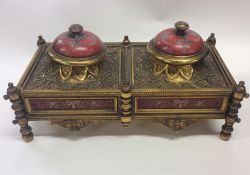 A good Continental brass inkwell decorated with sc