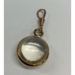 An unusual gold mounted crystal pendant with loop