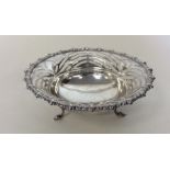 A circular silver pierced sweet dish decorated wit