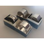 Four silver napkin rings of various dates and make